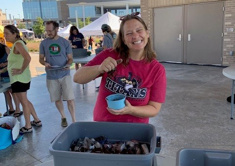 photo of worm bin workshop participant, female holding earthworms